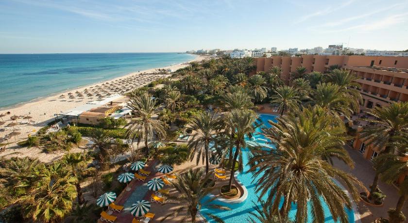 a beach filled with palm trees and palm trees, El Ksar Resort & Thalasso - Families and Couples Only in Sousse