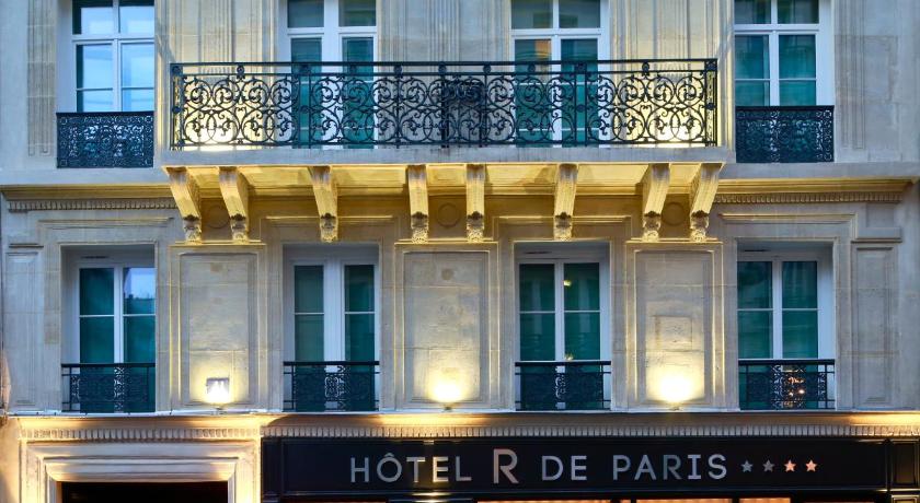 a large building with a clock on the front of it, Hotel R de Paris in Paris