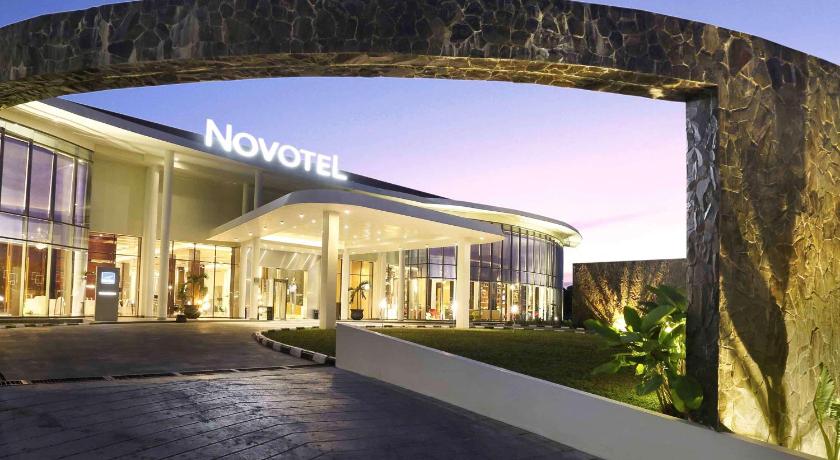 a large building with a clock on the side of it, Novotel Banjarmasin Airport Hotel in Banjarbaru