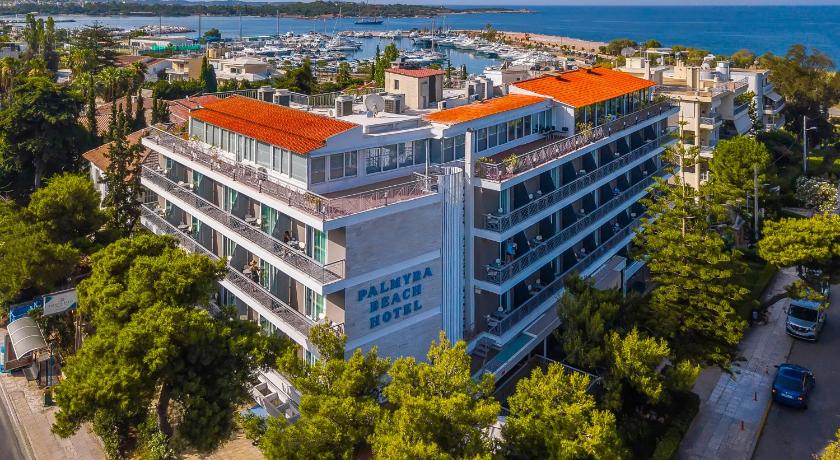 a large building with a lot of windows on top of it, Palmyra Beach Hotel in Athens