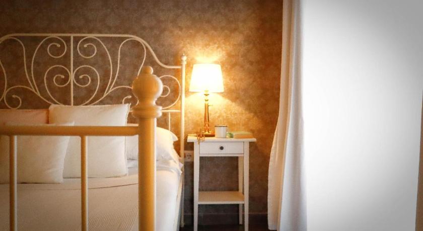 a bedroom with a bed and a lamp, Guest House Camilla in Alghero