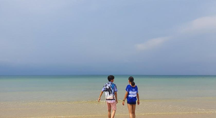 two people standing on a beach holding surfboards, Baan Imm Sook Resort (SHA Extra Plus) in Chanthaburi