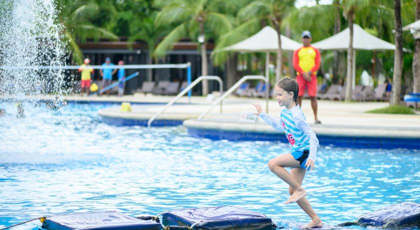 a girl jumping in the water with a frisbee, JPark Island Resort and Waterpark in Cebu