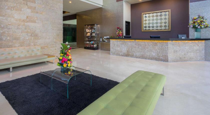 a living room with a couch and a table, GHL Hotel Barranquilla in Barranquilla
