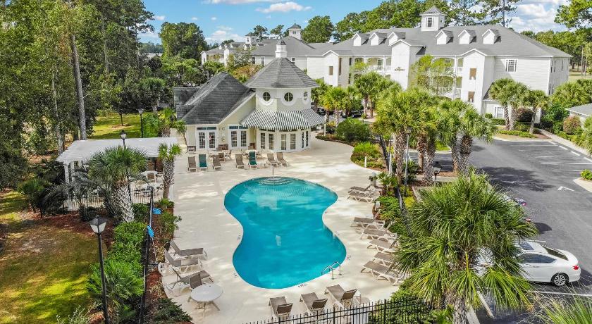 a large white house with a pool and trees, Grande Villas at World Tour Golf Resort in Myrtle Beach (SC)