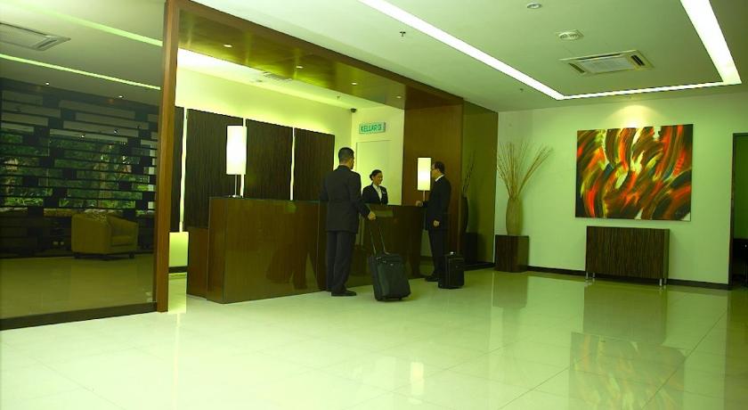 two men standing in a lobby with their suitcases, The Jerai Hotel Alor Setar in Alor Setar