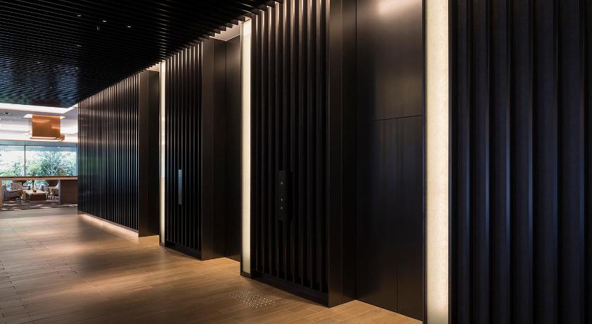 a large room with a large metal door, Cross Hotel Kyoto in Kyoto