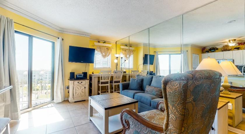 a living room filled with furniture and a large window, Plantation Dunes II in Gulf Shores (AL)