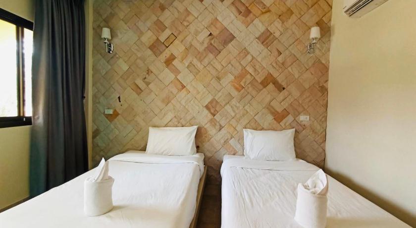 two beds in a hotel room with white walls, Wangpla Villa Resort in Nakhon Sawan