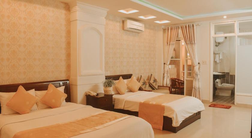 a hotel room with two beds and two lamps, Hue Harmony Hotel in Hue