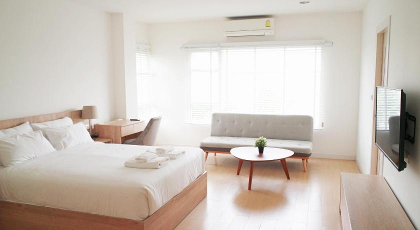 a room with a bed, table, chair and a tv, The White Garden Premier Saraburi in Saraburi