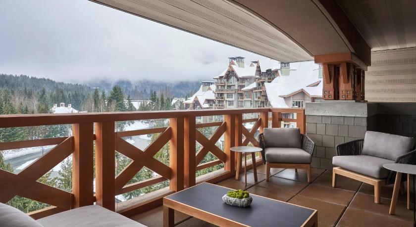 a living room filled with furniture and a balcony, Four Seasons Resort Whistler in Whistler (BC)