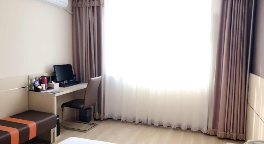 a hotel room with a bed, desk and television, 7 Days Premium Beijing Changping Subway Station in Beijing
