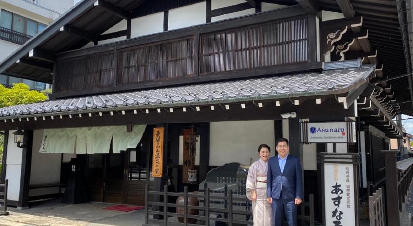 a man and woman standing in front of a building, Ryokan Asunaro in Takayama
