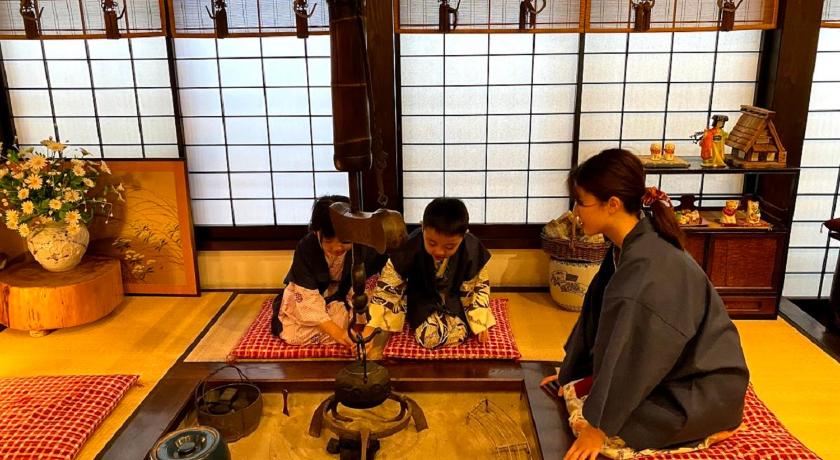 two people sitting at a table in a room, Ryokan Asunaro in Takayama