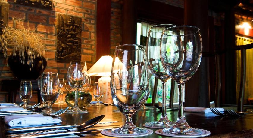 a table topped with glasses and wine glasses, Van Chai Resort in Thanh Hoá / Sầm Sơn Beach