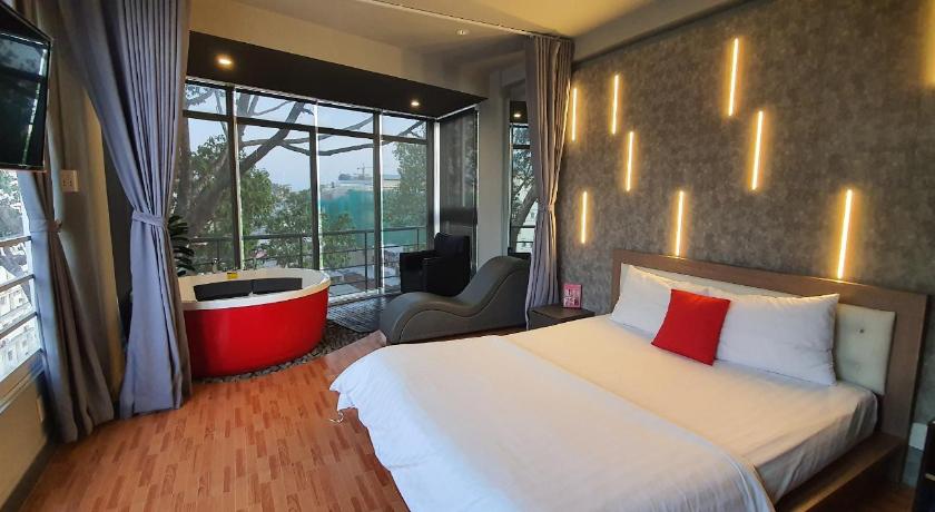 a hotel room with two beds and a large window, Bonita Boutique Hotel in Ho Chi Minh City