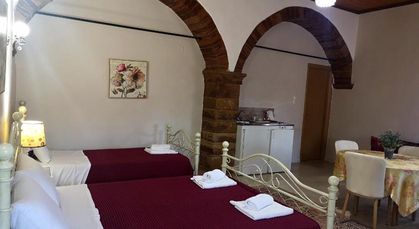 a hotel room with two beds and a fireplace, Clio apartments in Chios