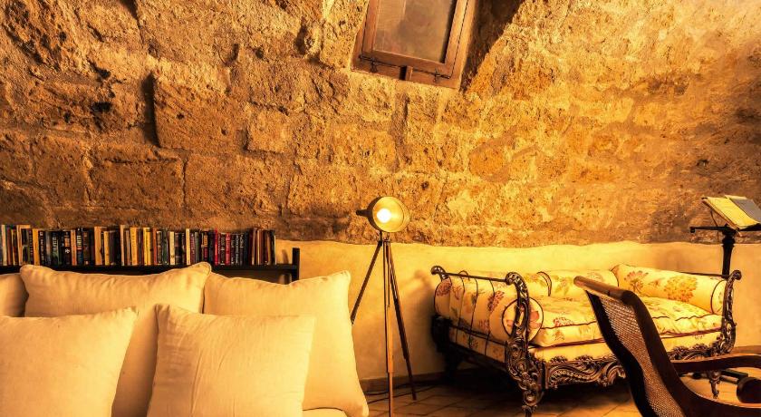 a living room with a couch, chair and a lamp, Corte della Maesta Antica Residenza in Bagnoregio
