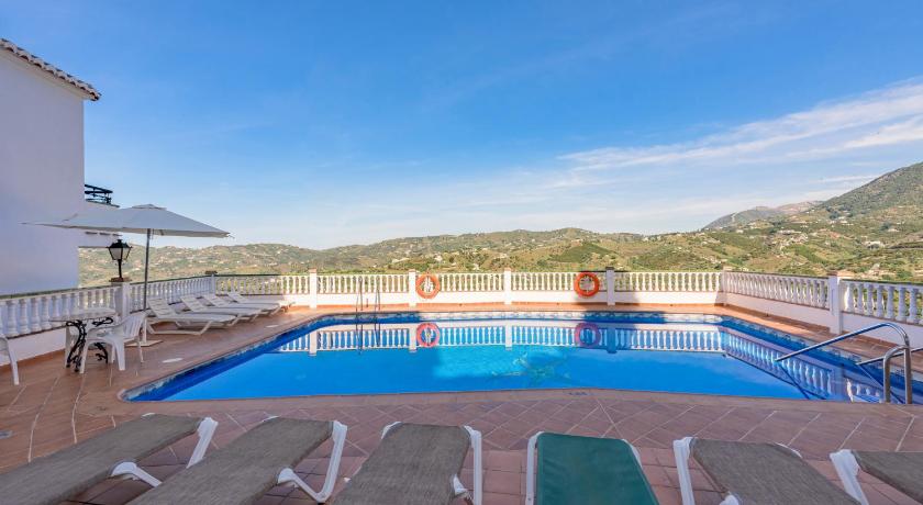 a swimming pool with a pool table and chairs, Apartamentos Rosamarina in Nerja