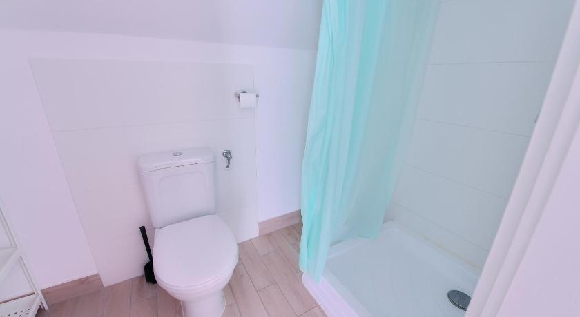 a white toilet sitting in a bathroom next to a bath tub, Oliver Inn in Balatonlelle
