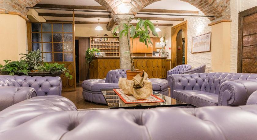 a living room filled with furniture and a dog, Hotel Il Telegrafo in Melegnano