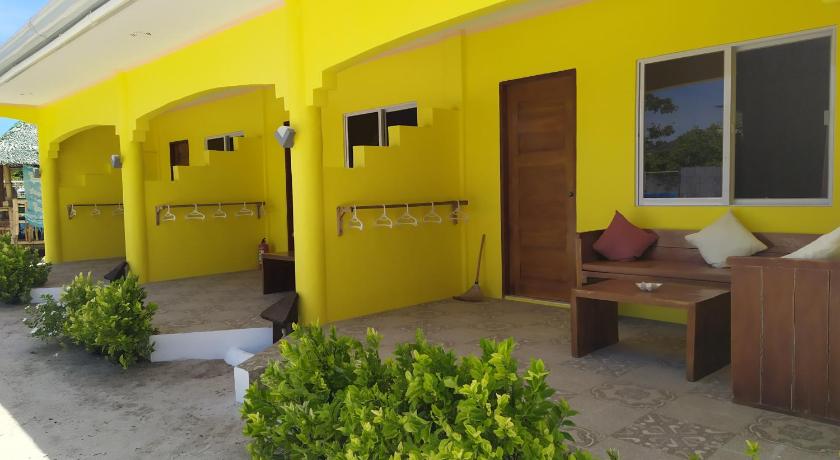 a row of yellow and green toilets next to a building, JPH Resort in Cebu