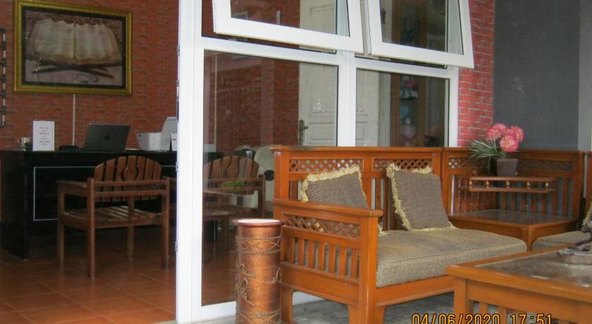 a living room filled with furniture and a window, Aqilakost & Cafe Gadog Puncak in Puncak