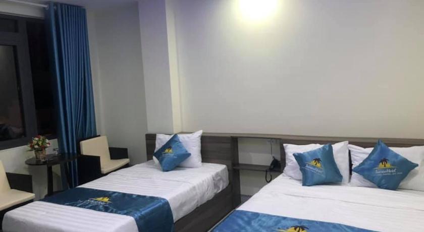 a hotel room with two beds and two nightstands, Sunrise Hotel in Quy Nhon (Binh Dinh)
