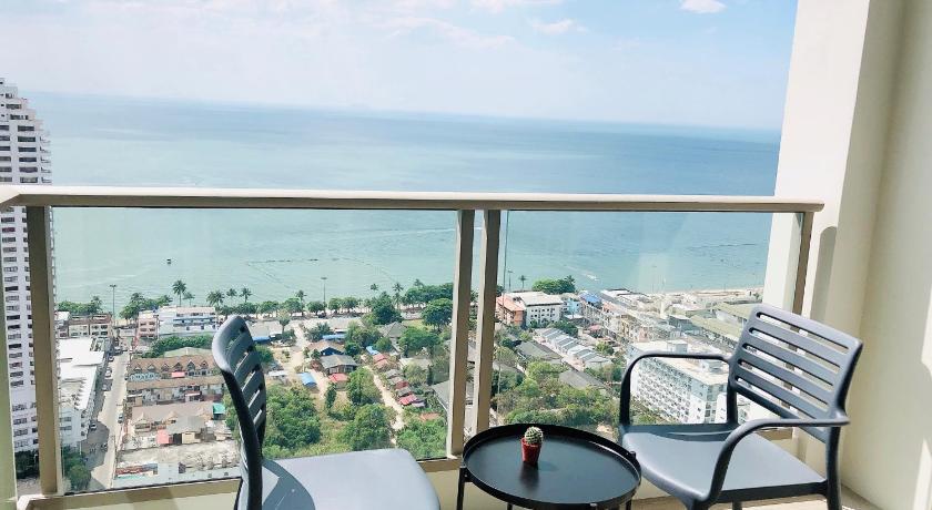 two chairs sitting on a balcony overlooking the ocean, Riviera Jomtien by Hello Pattaya 1 in Pattaya