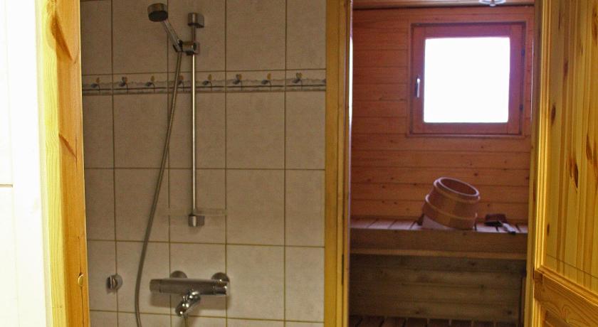 a bathroom with a shower, toilet and sink, Kotareitti Apartments in Rovaniemi