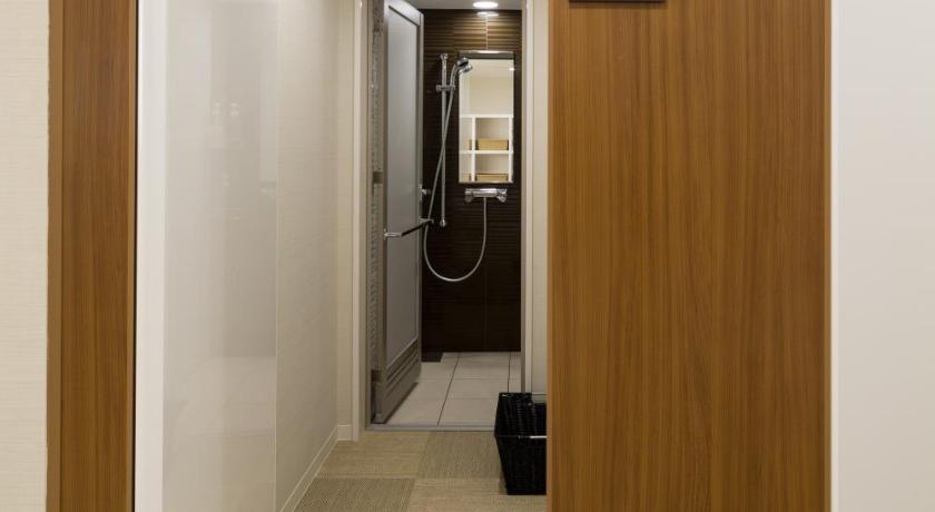 a hallway with a door leading to a room with a door leading to a, First Cabin Akasaka in Tokyo