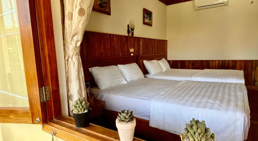a bed room with a white bedspread and pillows, Villa Lien Tho in Phu Quoc Island