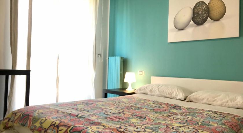 a bedroom with a bed, a lamp and a painting on the wall, ROOM 110 BARI -guesthouse- in Bari