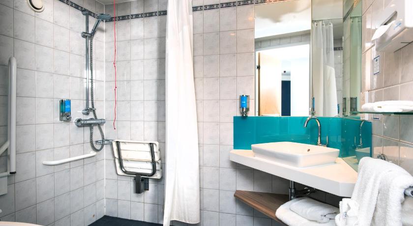 a bathroom with a sink, toilet and shower, Holiday Inn Express London Luton Airport in Luton