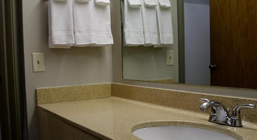 a bathroom with two sinks and a mirror, Days Inn & Suites by Wyndham Bloomington/Normal IL in Bloomington (IL)