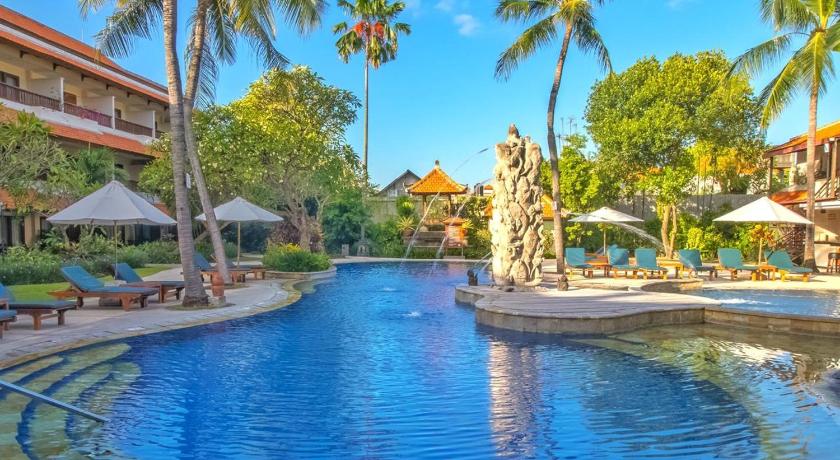 a large swimming pool in a tropical setting, Bali Rani Hotel in Bali