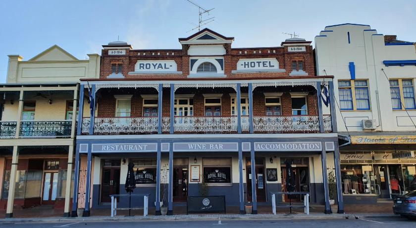 a large building with a clock on the front of it, The Royal Hotel in West Wyalong