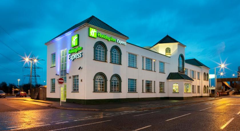 a large building with a clock on the side of it, Holiday Inn Express London Chingford in London