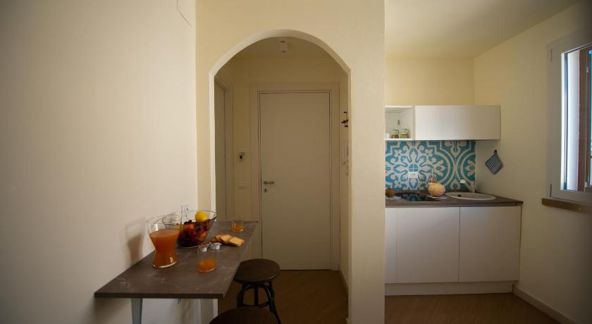 a kitchen with a table and a sink, San Vito Accommodations in San Vito Lo Capo