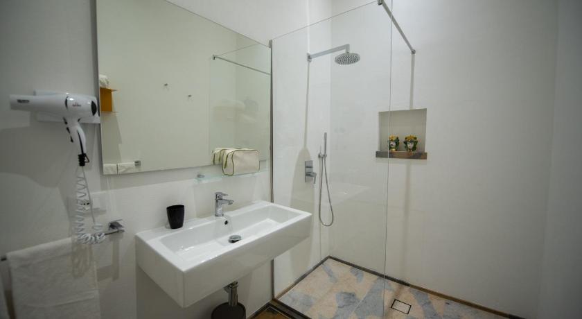 a bathroom with a sink and a mirror, San Vito Accommodations in San Vito Lo Capo