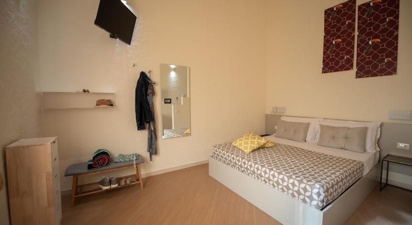 a bedroom with a bed, a dresser, and a television, San Vito Accommodations in San Vito Lo Capo