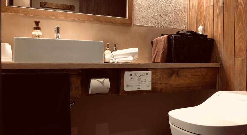 a bathroom with a toilet, sink, and mirror, RoheN Resort&Lounge HAKONE in Hakone