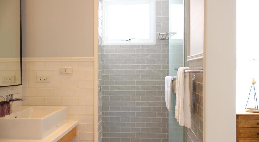 a bathroom with a shower, sink, and mirror, Notting Leaf BnB in Penghu