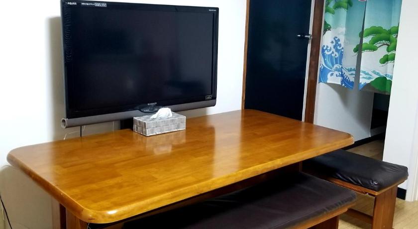 a living room with a tv and a table, NOAH HOSTEL TOKYO in Tokyo