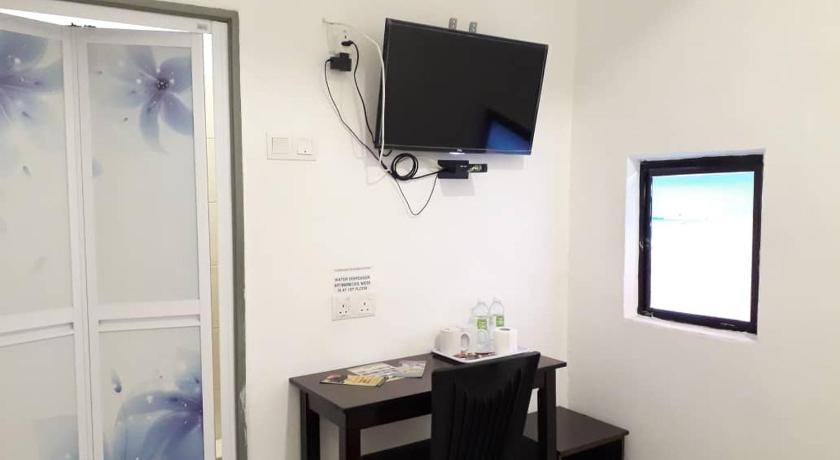 a living room with a tv and a window, Max Ferringhi Hotel in Penang
