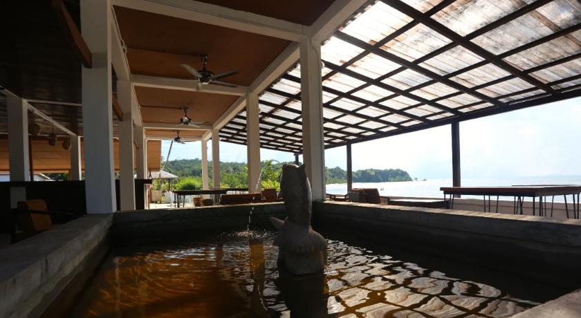 a large pool of water next to a building, Rafflesia Resort in Lundu