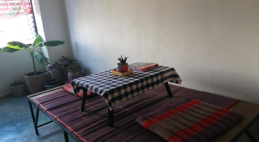a table with a blanket on top of it, Chill pill Hostel in Chiangkhan
