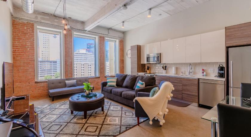 a living room filled with furniture and a large window, GA Living Suites- Downtown Dallas Corporate Suites in Dallas (TX)