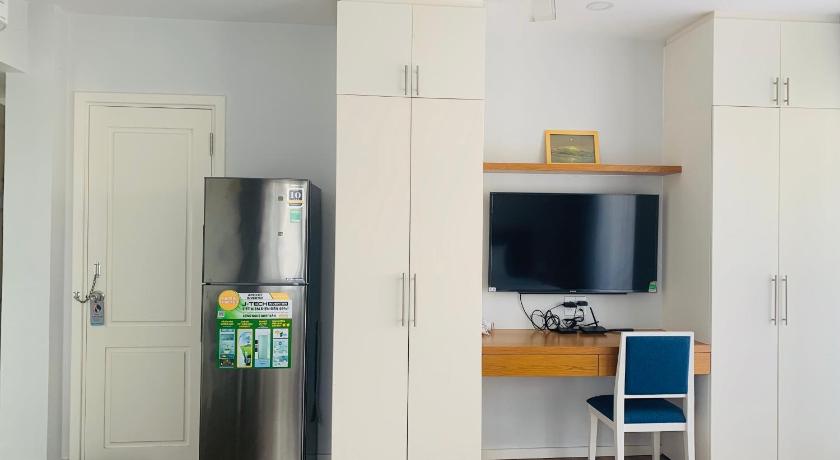 a kitchen with a refrigerator and a microwave, Ocean pearl Villa in Vung Tau